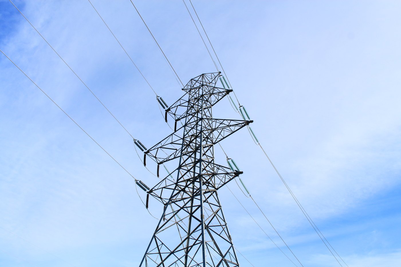 A high-voltage transmission tower against open sky near Lethbridge, Alberta