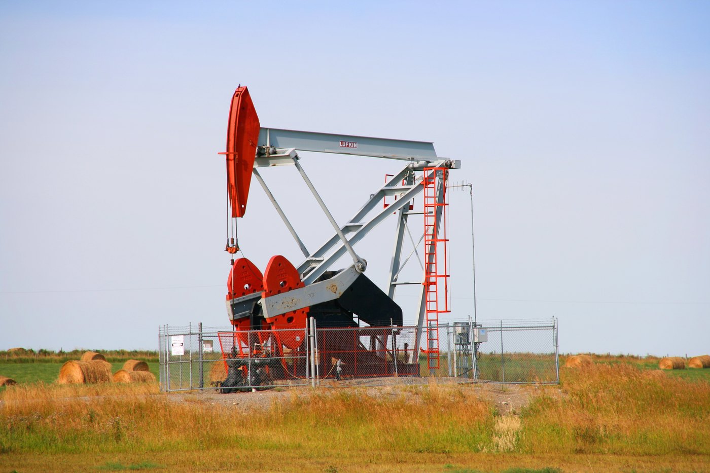 A pumpjack at an oil well on open Alberta prairie