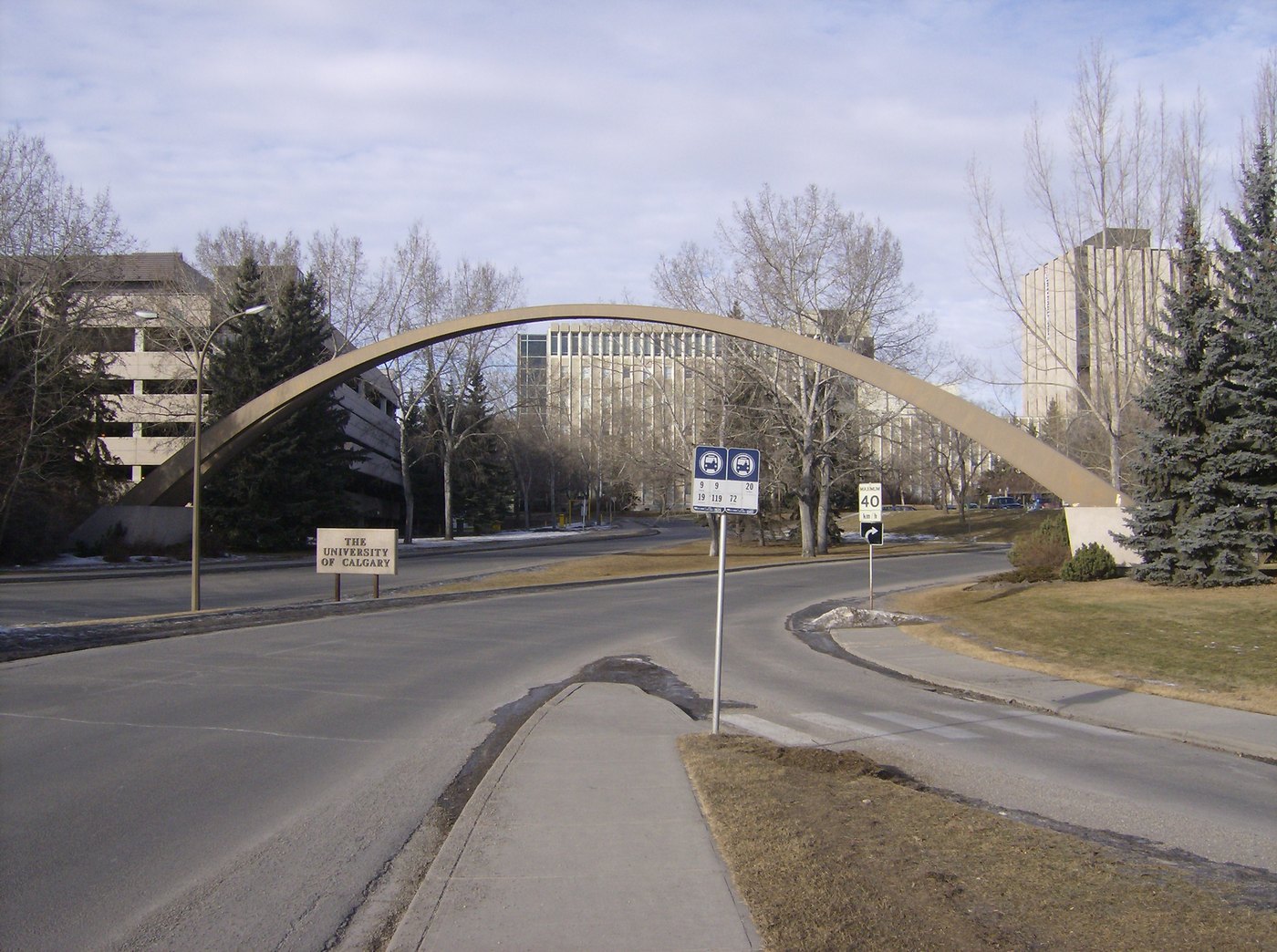 The entrance arch and campus sign at the University of Calgary, with university buildings behind